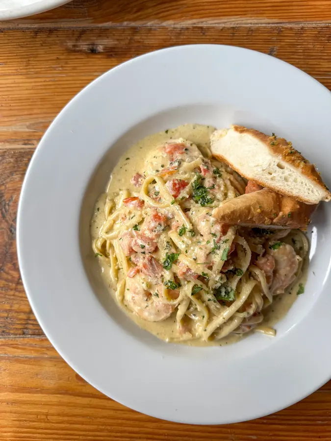 Pasta with a creamy sauce and garlic bread