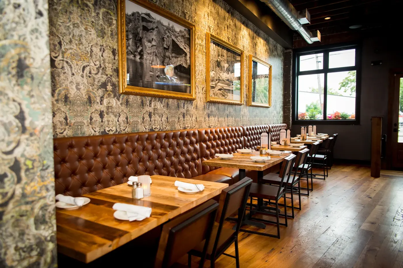 Dining room with leather banquettes and wood tables