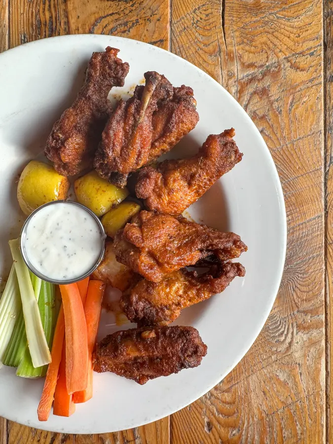 Plate of chicken wings with blue cheese and celery